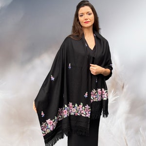 May include: A black shawl with a floral embroidery design. The shawl has a fringe border and is made of a soft, luxurious fabric.