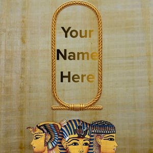 May include: Gold-colored cartouche with the words "Your Name Here" in gold lettering, above three Egyptian pharaohs. The background is a textured, tan papyrus.