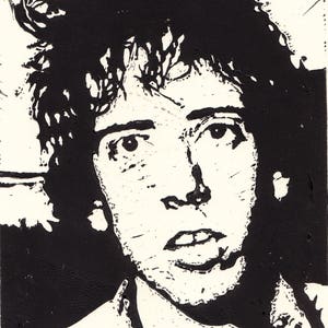 May include: Black and white illustration of a person with short, messy hair. The person is looking directly at the viewer with a serious expression. The illustration is done in a simple, graphic style.