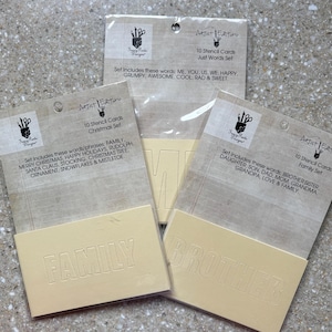 May include: Three sets of stencil cards with the words "FAMILY", "BROTHER", and "ME" visible. Each set includes 10 cards with various words and phrases. The packaging includes the text "Artist Edition" and "Happy Hands Designs".