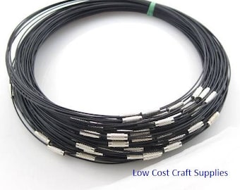 May include: A black 18-inch (46 cm) stainless steel wire choker necklace with silver-toned barrel clasps.