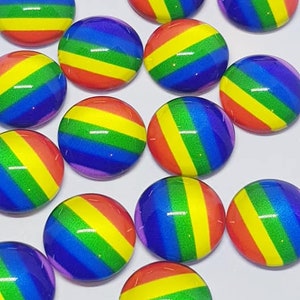 May include: A collection of rainbow-colored round glass cabochons. The cabochons have a glossy finish and feature a diagonal stripe pattern.