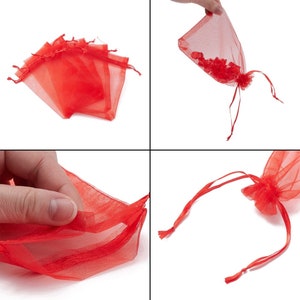 May include: A set of red organza gift bags with drawstrings. The bags are made of sheer fabric and are perfect for small gifts or favors.