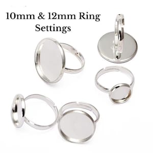 May include: Silver-toned ring settings with flat, round bezels in 10mm and 12mm sizes. The rings have adjustable bands and are displayed against a white background. Text at the top reads "10mm & 12mm Ring Settings."
