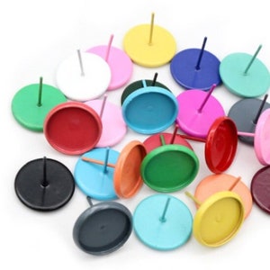 May include: Assortment of colourful round metal earring bases with posts. The bases are in various colours, including red, green, blue, yellow, pink, white, black, and grey.
