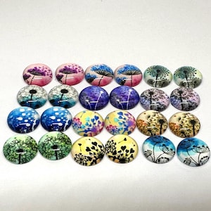 May include: Assortment of 18 round glass cabochons with dandelion designs in various colours, including blue, green, pink, purple, and yellow.