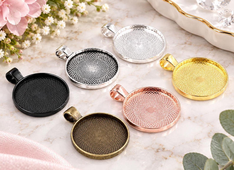 May include: A collection of six circular metal pendant trays featuring a textured, geometric lattice pattern on the interior base. The set includes finishes in matte black, silver, gold, rose gold, and antique bronze, each with a top bail loop.