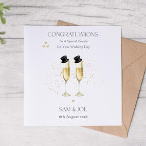 May include: A wedding card with the words "CONGRATULATIONS" and "To A Special Couple On Your Wedding Day". Two champagne flutes with top hats are featured. The names "SAM & JOE" and the date "6th August 2026" are also included.