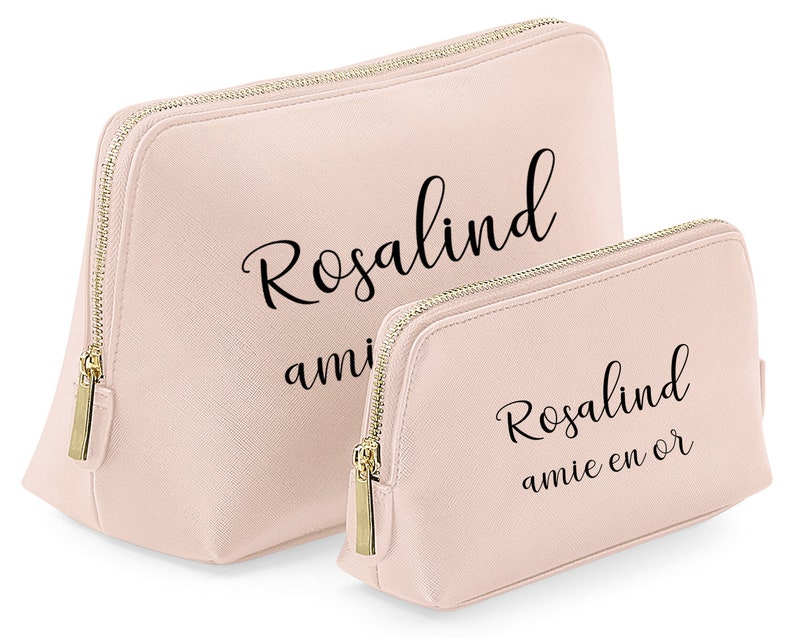 May include: Two pink zippered cosmetic bags with gold zippers. The larger bag has the text "Rosalind amie" printed on it. The smaller bag has the text "Rosalind amie en or" printed on it.