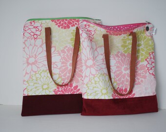 May include: Two tote bags with floral print fabric and burgundy bottom panels. The bags have brown leather straps.