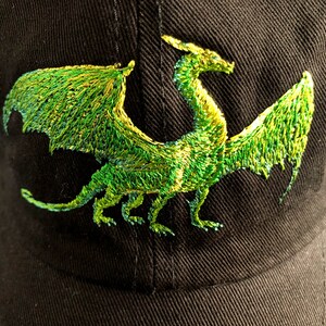 May include: A black baseball cap with an embroidered green dragon design.