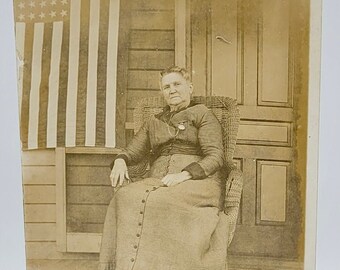 American Flag Displayed~RPPC~Older Woman Sitting on Porch~Photo Postcard~Patriotic