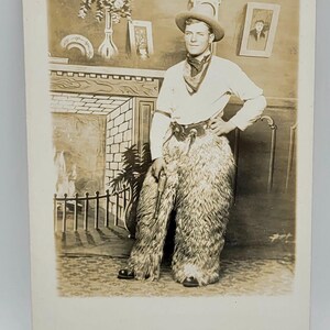 Chaps laineux de cow-boy ~ CPRP ~ pistolet ~ chapeau western ~ toile de fond de type arcade ~ cheminée