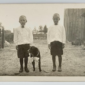 Two Boys & Dog Wearing Bow~RPPC~Mack Rover and George~Farm Country Setting