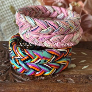 May include: Three braided bracelets in shades of pink, orange, blue, and green. The top bracelet is primarily pink with a marbled effect. The middle bracelet is a vibrant mix of colors. The bottom bracelet is a mix of orange, blue, and green. The text "Sangis Creative Corner" is visible.