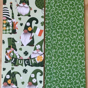 May include: St. Patrick's Day themed bookmarks featuring green gnomes with white beards, holding Irish flags and pots of gold. The bookmarks have a light green background with shamrocks and the word "LUCK".