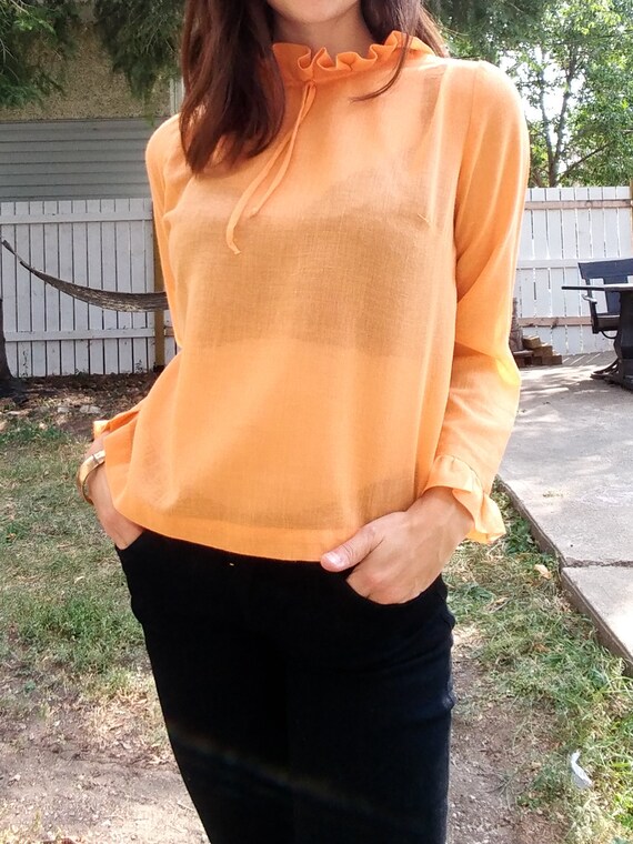 orange ruffle blouse