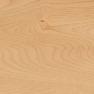 May include: Close-up of a light-colored wood grain pattern. The wood has a natural, warm tone with visible grain lines and a knot. The surface appears smooth and polished, showcasing the wood's natural beauty.