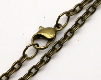 May include: A close-up of a bronze chain necklace with a lobster clasp. The chain is made of small, oval-shaped links.