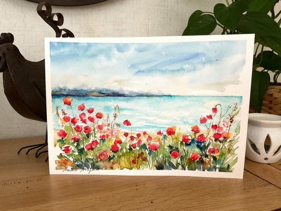 海辺に咲く赤いポピーを描いたオリジナルの水彩画。鮮やかな赤いポピー