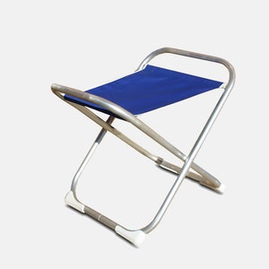 Peut inclure: Une chaise pliante argentée avec un siège en toile bleu. La chaise a un design simple et est légère et portable.