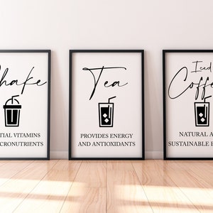 May include: Three black framed prints with white backgrounds and black text. The first print says "Shake" with a black and white illustration of a milkshake. The second print says "Tea" with a black and white illustration of a glass of iced tea. The third print says "Iced Coffee" with a black and white illustration of a glass of iced coffee.