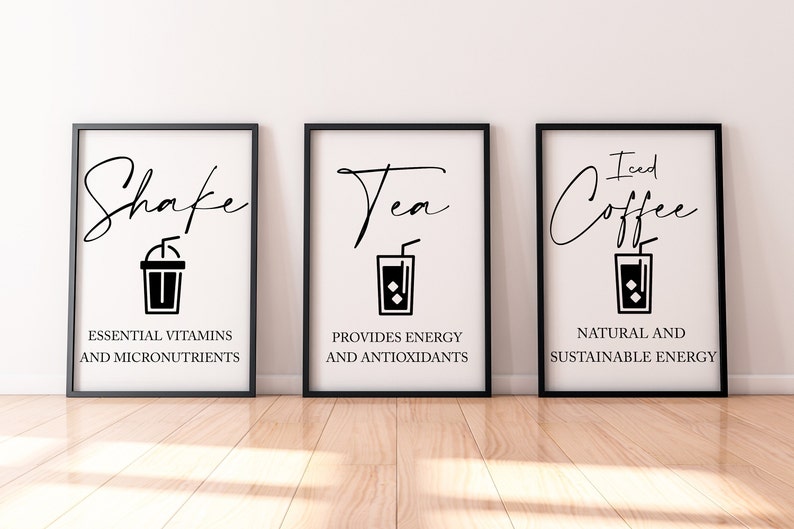May include: Three black framed prints with white backgrounds and black text. The first print says "Shake" with a black and white illustration of a milkshake. The second print says "Tea" with a black and white illustration of a glass of iced tea. The third print says "Iced Coffee" with a black and white illustration of a glass of iced coffee.