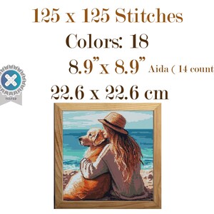 May include: Cross-stitch pattern of a woman and a golden retriever dog on a beach, framed in wood. The pattern is 8.9" x 8.9" (22.6 x 22.6 cm) with 125 x 125 stitches and 18 colors. The text reads "125 x 125 Stitches Colors: 18 8.9" x 8.9" Aida (14 count) 22.6 x 22.6 cm".