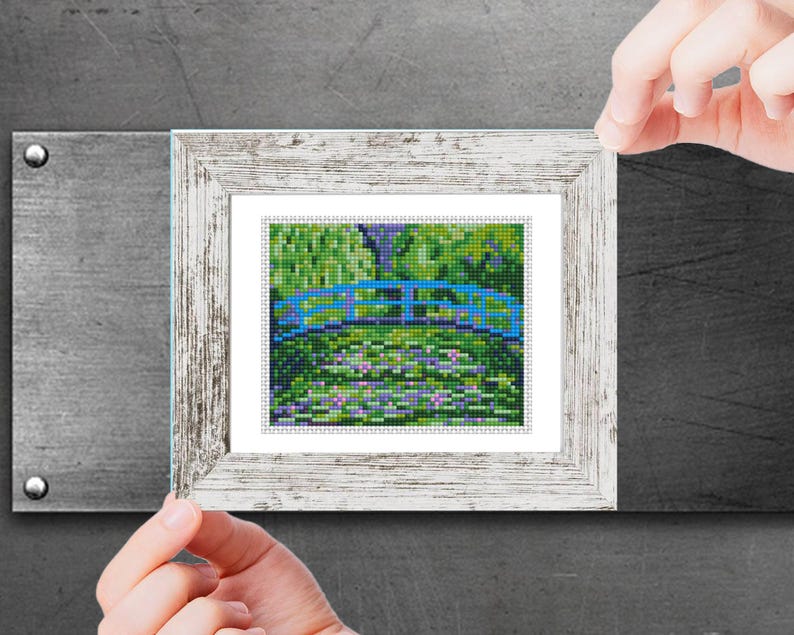 A cross stitch pattern of The Japanese Footbridge by  Claude Monet  painting. The pattern is 50 stitches wide and 60 stitches high. The pattern is made with 11 colors. The text 'MINI Cross Stitch Pattern PDF' is at the top of the image. The text '50w x 60h Stitches' and '15 Colors' is on the right side of the image. The text 'Nikki Pattern MODERN CROSS STITCH PATTERNS www.etsy.com/shop/Nikki Pattern' is at the bottom of the image.