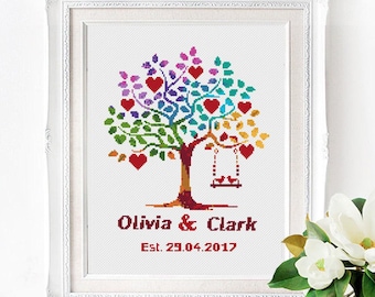 May include: Cross stitch pattern of a colorful tree with red hearts and a swing. The text below reads "Olivia & Clark Est. 29.04.2017".