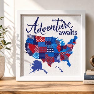 Puede incluir: Una obra de arte en punto de cruz enmarcada con un mapa de los Estados Unidos. El mapa est&aacute; compuesto por patrones de patchwork rojos, blancos y azules. Las palabras "Adventure awaits" est&aacute;n bordadas en azul marino sobre el mapa.