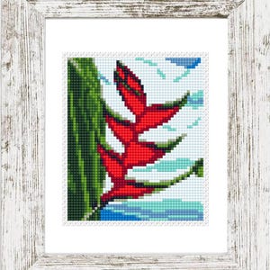 May include: Cross-stitch art of a red tropical flower with green leaves and blue water, framed in a white distressed wood frame. The artwork is a detailed pixelated image, perfect for home decor.