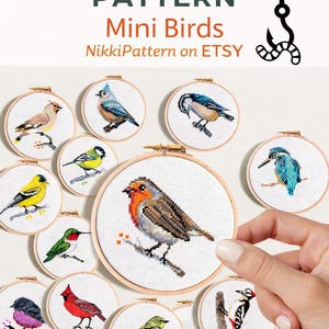 May include: A collection of cross-stitch patterns featuring various mini bird designs, each displayed in a wooden embroidery hoop. The image includes a robin, hummingbird, and other colorful birds. Text reads "Cross Stitch Pattern Mini Birds" and "Instant Download PDF".