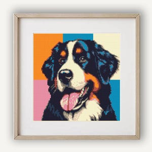 May include: A Bernese Mountain Dog with black, white, and brown fur is depicted in a colorful, pixelated style. The dog's tongue is sticking out, and its eyes are closed. The background is a patchwork of orange, pink, blue, and white squares.