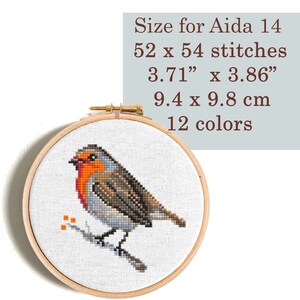 Cross stitch pattern of a robin on a branch with orange berries. The pattern is 52 x 54 stitches and uses 12 colors. The finished size is 3.71 inches by 3.86 inches or 9.4 cm by 9.8 cm. Size for Aida 14.