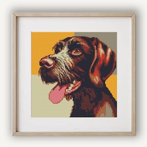 May include: Framed print of a dog's portrait in a pixelated style. The dog has brown fur, a pink nose, and a pink tongue. The background is divided into sections of yellow, gray, and orange.