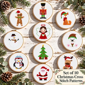 May include: A set of ten circular wooden embroidery hoops containing cross-stitch patterns of Christmas characters including a gingerbread man, nutcracker, fox, angel, snowman, polar bear, penguin, Christmas tree, reindeer, and Santa Claus.
