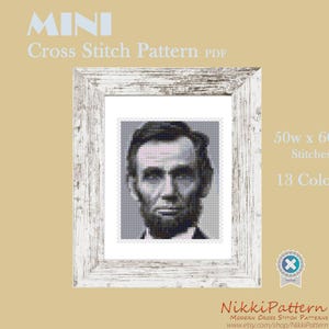 May include: A black and white cross stitch pattern of Abraham Lincoln's portrait in a white frame. The pattern is 50 stitches wide by 60 stitches high and uses 13 colours.