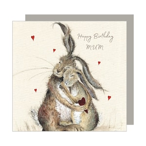 May include: A birthday card with a watercolour illustration of two hares embracing. The card reads "Happy Birthday Mum" in script, with small red heart details. The hares are depicted with soft, brown fur.