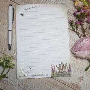 May include: A white lined notepad with a bee and the text "A happy pair of Hee-Haw's!" at the top. The bottom of the notepad has a drawing of two donkeys and the text "Love Country by Sarah Reilly" and "www.lovecountrybysarahreilly.co.uk".