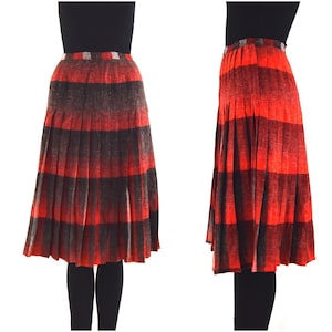 May include: A red and black plaid pleated skirt with a mid-length hemline.