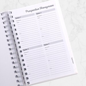 May include: Open spiral-bound notebook with a page titled "Prospective Honeymoon." The page is divided into sections for comparing options, with spaces for destination, notes, pros, and cons. The notebook is white with gray text.