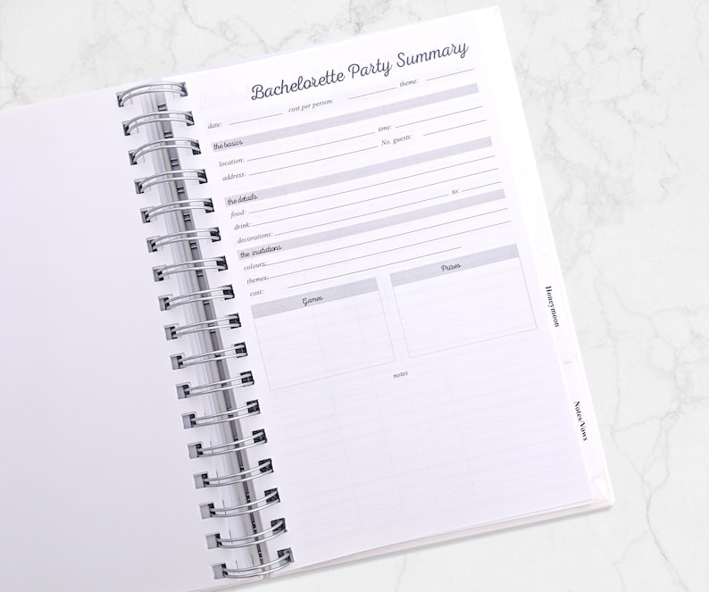 May include: Open spiral-bound notebook with a "Bachelorette Party Summary" page. The page includes sections for date, location, food, decorations, and more. The notebook is open on a white marble surface.
