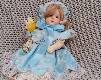 Antique replica of German style 8" porcelain and wooden articulated blonde Victorian girl doll with her pet canary