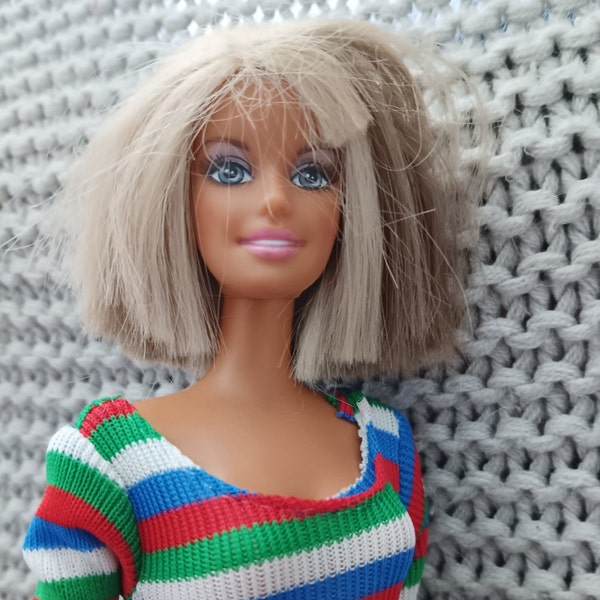 Vintage early 200's Barbie wearing a vintage MOD outfit from the 1970's - striped top, pocketed red skirt and go-go boots