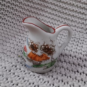 Antique Japanese Hand Painted Ceramic Pitcher with Pagoda on the River Illustration