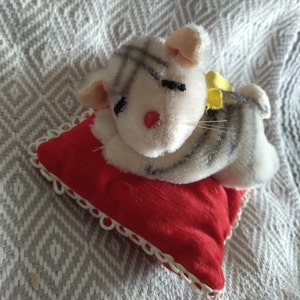 Vintage stuffed white tiger sleeping on a red pillow plushie