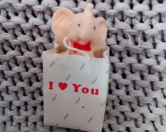 Vintage Cutesy Pink Elephant in an I love you gift bag refrigerator magnet from the 1980's