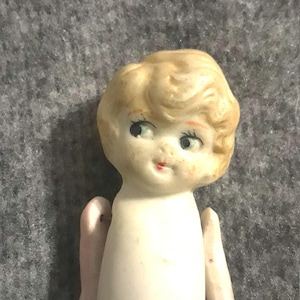 Antique bisque JAPAN kewpie with articulated arms, blonde flapper with googly eyes