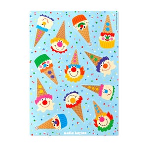 May include: A sheet of colorful clown ice cream cone stickers on a light blue background with confetti. The stickers feature a variety of clown faces with different colored hair and hats.